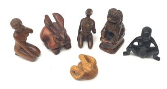 A group of six Japanese carved wooden netsukes modelled in various forms, comprising rabbit, temple