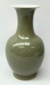 A celadon glaze vase, of baluster form with tall neck and flared rim, with foliate decoration, paint