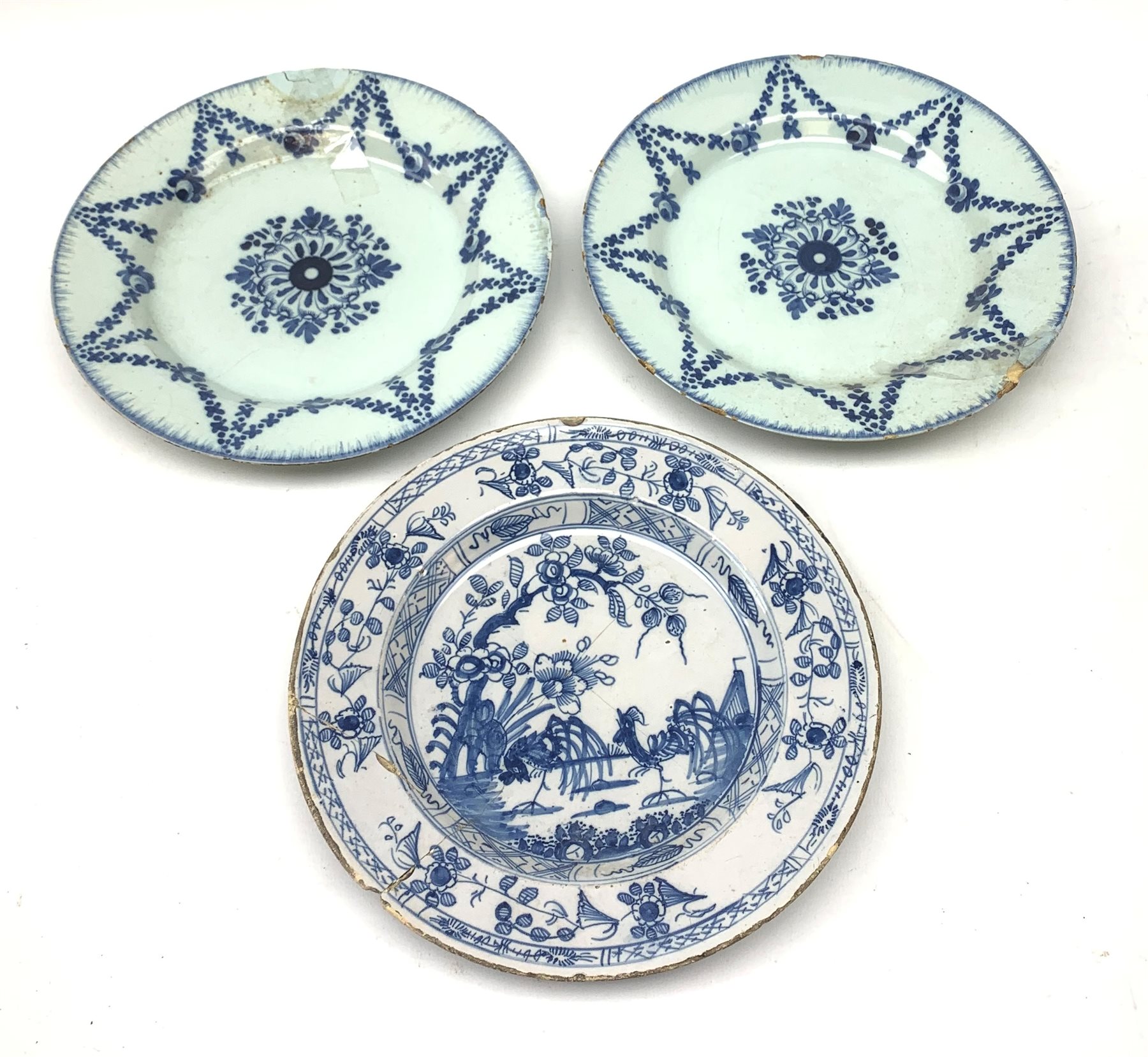 Pair of 18th Century English Delft blue and white plates decorated with a central floral roundel enc