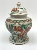 Chinese Qing Dynasty Famille Verte jar and cover decorated with Dragons and butterflies amongst fol