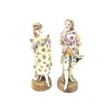 A pair of Continental porcelain figurines, the first modelled as a female figurine in floral dress,