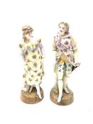 A pair of Continental porcelain figurines, the first modelled as a female figurine in floral dress,