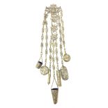 A Victorian metal chatelaine, the scrolling pierced and mask and putti decorated clip suspending sev