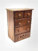 A Victorian pine miniature straight front chest of two short and two long drawers, the platform base