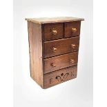 A Victorian pine miniature straight front chest of two short and two long drawers, the platform base