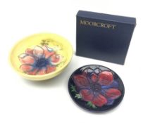 A Moorcroft dish, decorated with the Clematis pattern upon a yellow ground, with paper label beneath