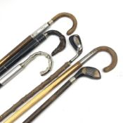 Six assorted walking sticks, four with snooker cue canes, to include an example with handle modelled