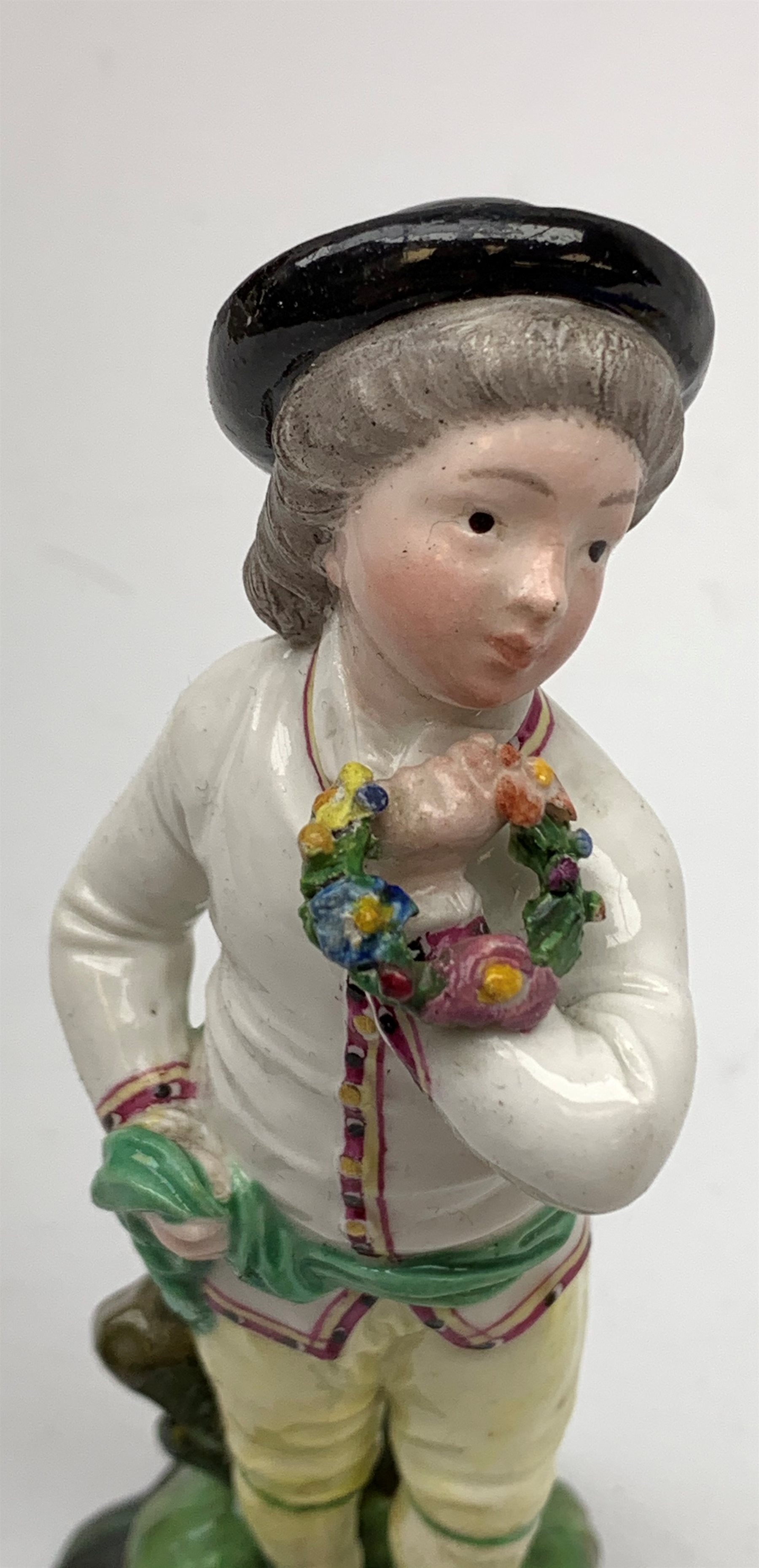 A 19th century H�chst porcelain figure, modelled as a young boy holding a Garland of flowers, H14cm, - Image 4 of 5