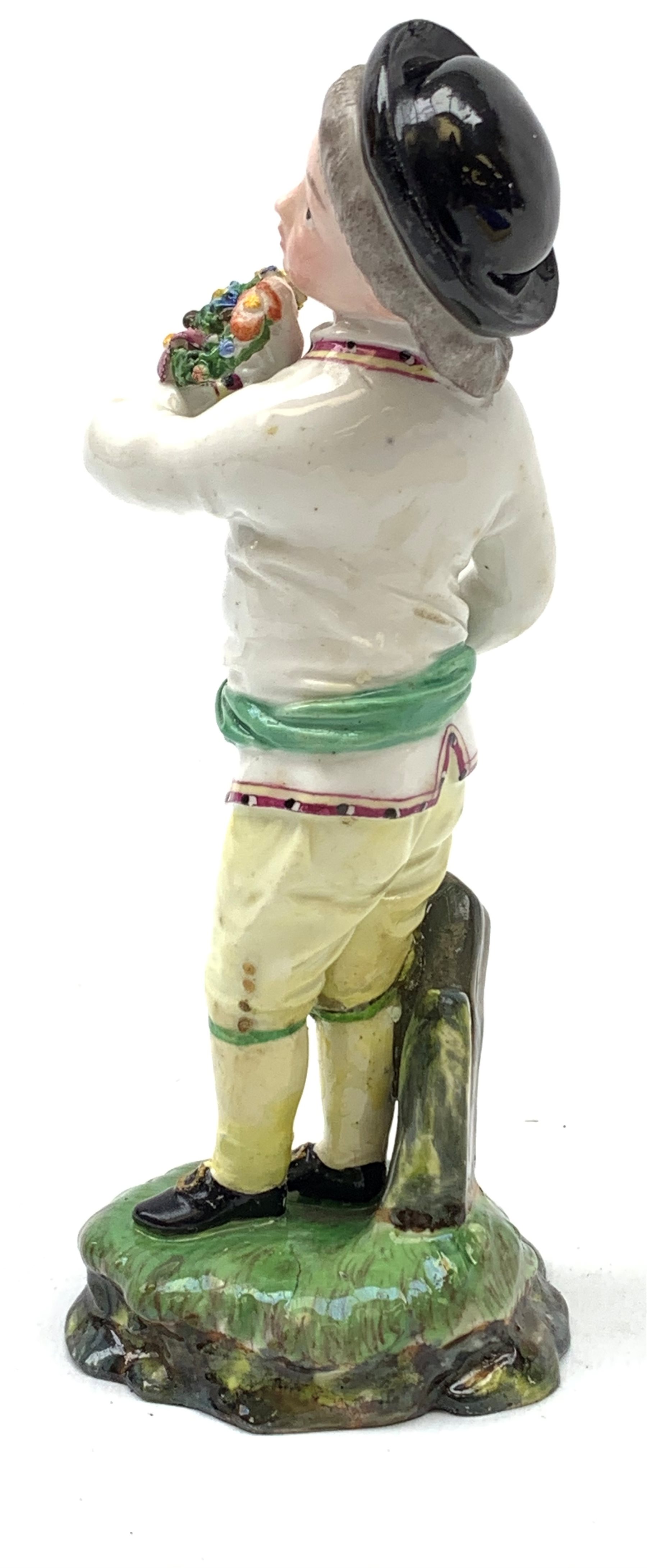 A 19th century H�chst porcelain figure, modelled as a young boy holding a Garland of flowers, H14cm, - Image 2 of 5