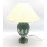A Wedgwood green Jasperware table lamp, of ovoid form upon a spreading circular foot, decorated with
