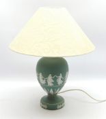 A Wedgwood green Jasperware table lamp, of ovoid form upon a spreading circular foot, decorated with