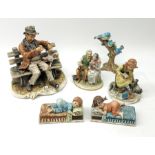 A selection of Capodimonte figures, comprising a large figure group modelled as a tramp on a bench w