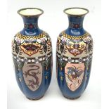 A pair of 20th century Japanese cloisonne vases, of fluted baluster form, decorated with panels cont