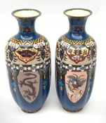 A pair of 20th century Japanese cloisonne vases, of fluted baluster form, decorated with panels cont