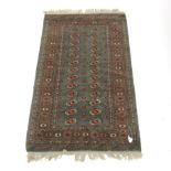 Persian Bokhara green ground rug, repeating field, 153cm x 95cm