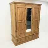 Solid pine triple wardrobe projecting cornice, two doors flanking single central mirror panel above