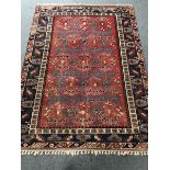 Turkish red and blue ground rug, geometric patterned field, repeating border, 272cm x 202cm