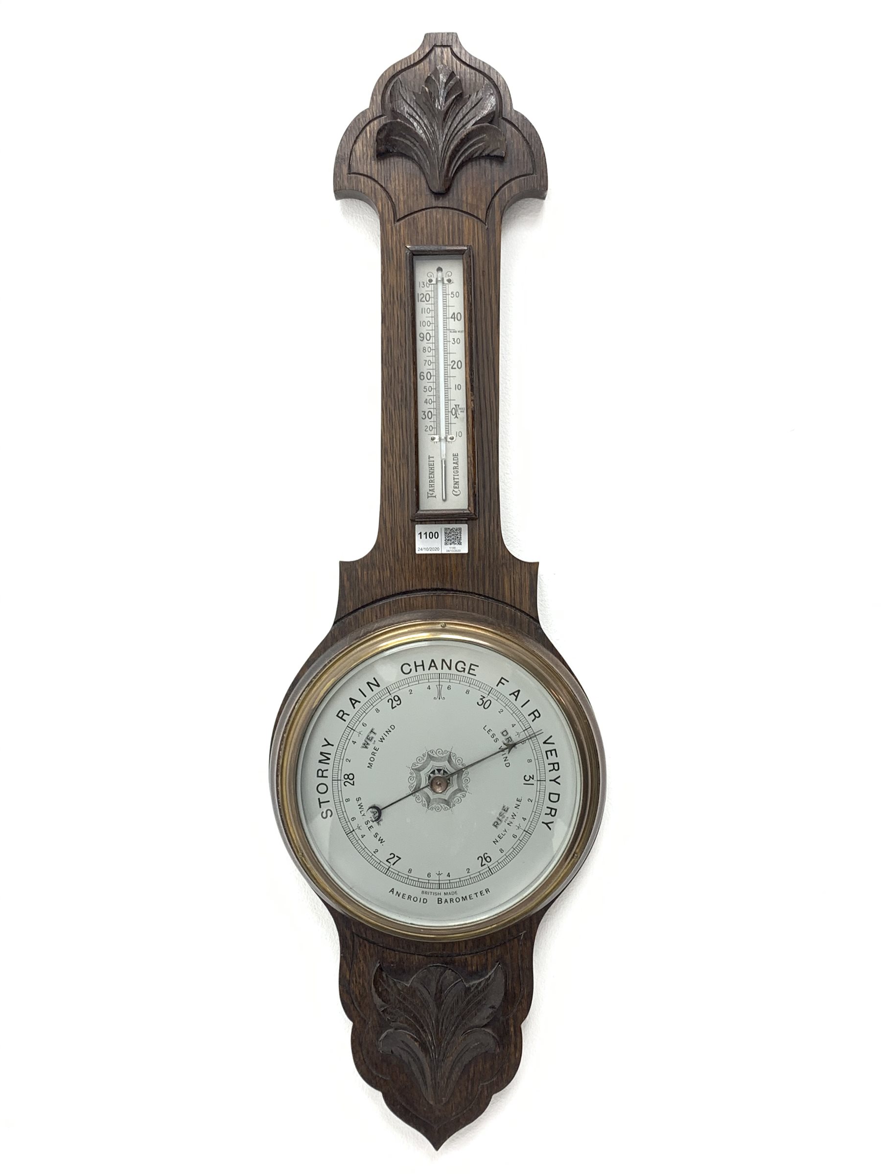 Early 20th century oak barometer, shaped pediment with foliage carved mount, mercury thermometer and