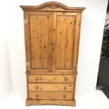 Solid pine wardrobe, shaped projecting cornice, two doors above three drawers, plinth base, W104cm,