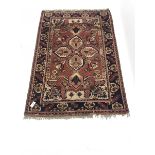 Turkish red ground rug , central medallion, repeating border, 178cm x 121cm
