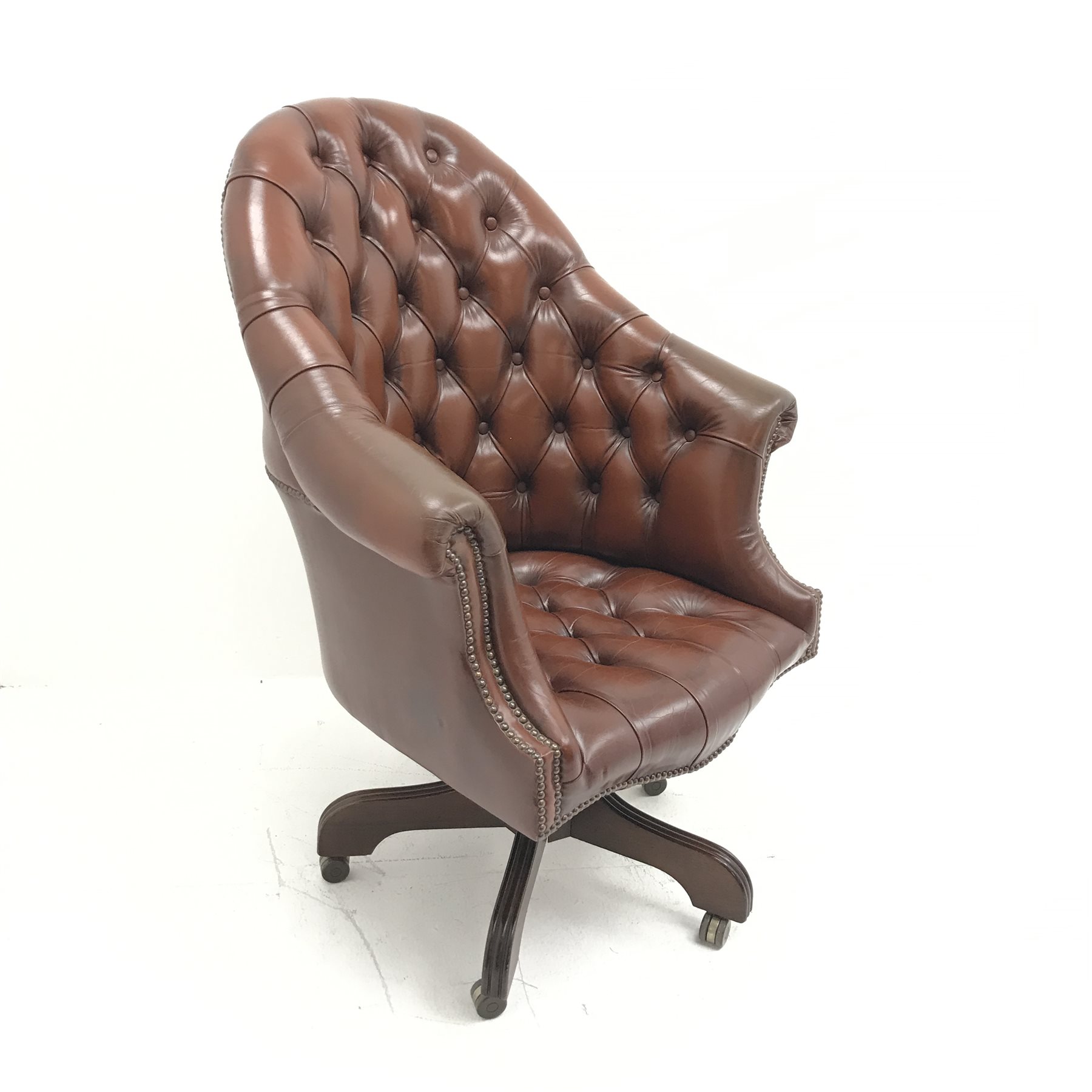 Library style swivel reclining desk chair, upholstered in deep buttoned and studded brown leather, f