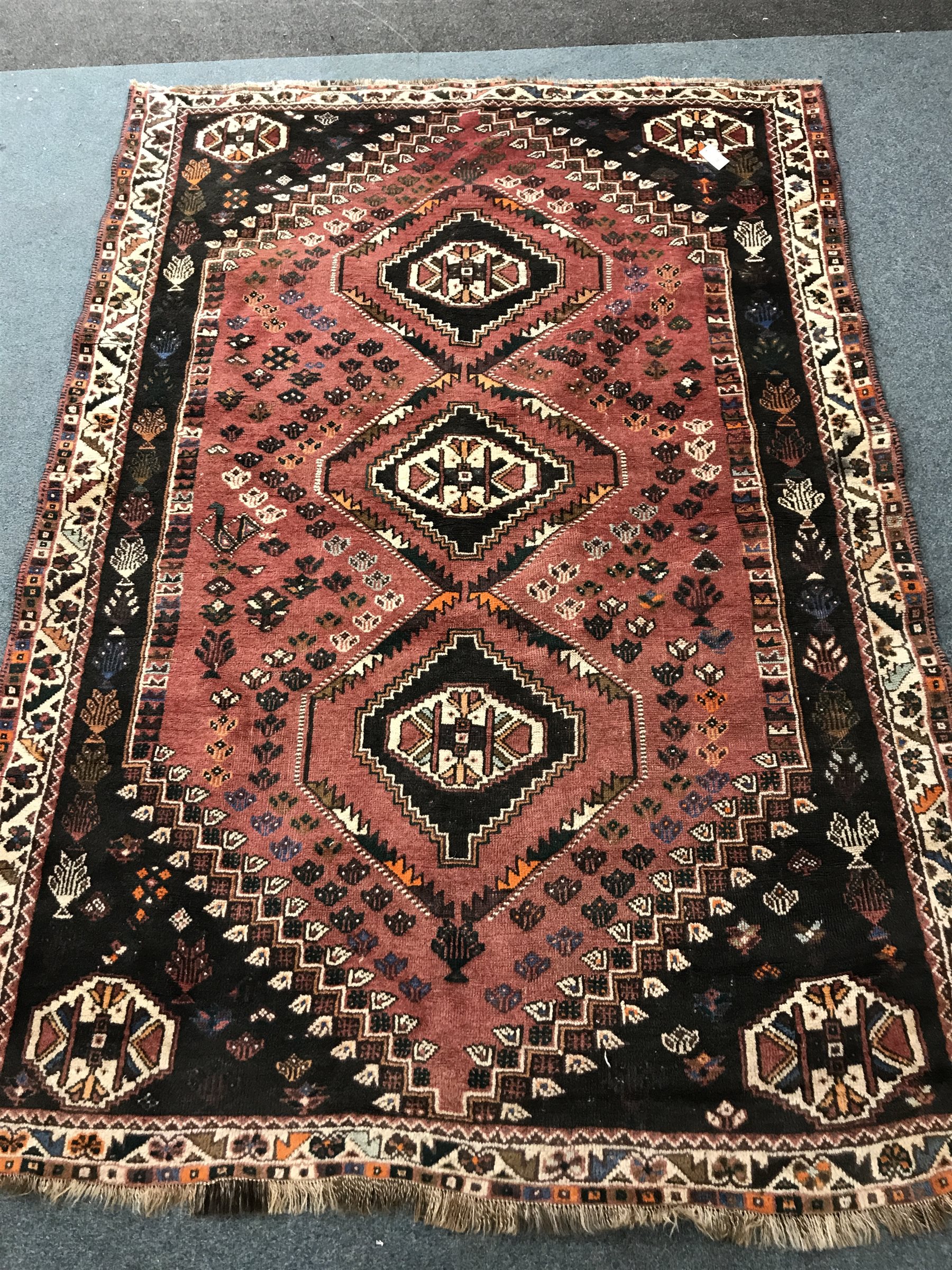 Shiraz red ground rug, three central medallions, 254cm x 177cm