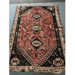 Shiraz red ground rug, three central medallions, 254cm x 177cm