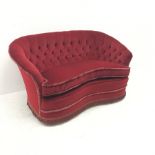 Early 20th Century kidney shaped two sofa upholstered in deep buttoned red fabric, W147cm