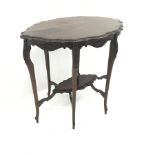 Early 20th century shaped walnut centre table, floral carved cabriole legs joined by single undertie