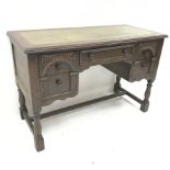Mid 20th century oak writing desk, green leather inset top, five drawers, baluster supports joined b