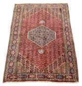 Persian Hamadan rug, lozenge red ground field decorated all over with stylised flower head motifs, p