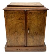 Victorian figured walnut and tulipwood banded table top cabinet, two doors enclosing three drawers