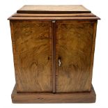 Victorian figured walnut and tulipwood banded table top cabinet, two doors enclosing three drawers