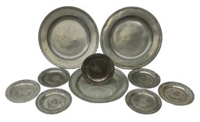 Collection of early 18th century pewter, comprising three large chargers, and seven plates, with var