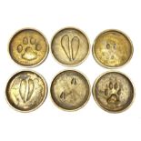 Rowland Ward (British Taxidermist: 1848�1912), set of six African Animal brass paw print coasters, c