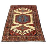 Persian rug carpet, cream ground field decorated with large red and blue central medallion and two l