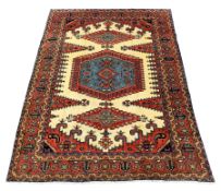 Persian rug carpet, cream ground field decorated with large red and blue central medallion and two l