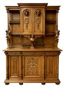 Late 19th century Flemish oak dresser, projecting cornice over two arched panelled doors with carved