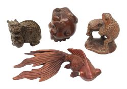 Three Japanese Meiji carved wooden netsukes, comprising dragon, skull with snake, and two frogs on l