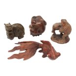 Three Japanese Meiji carved wooden netsukes, comprising dragon, skull with snake, and two frogs on l