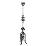 Arts and Crafts wrought iron oil lamp/candle stand, with decorative scroll work, H186cm