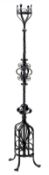 Arts and Crafts wrought iron oil lamp/candle stand, with decorative scroll work, H186cm