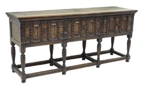 17th century style oak sideboard, three large drawers, heavily carved front, on tapering supports c