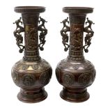 Pair of large Japanese bronze vases, of baluster form with tall neck and flared rim, having twin dra