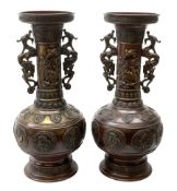 Pair of large Japanese bronze vases, of baluster form with tall neck and flared rim, having twin dra