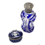 Late 19th century silver mounted glass scent bottle, the blue flash cut waisted body with foliate em