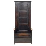 Early 18th century country oak bacon settle, tall raised cupboard back enclosed by paneled door, box