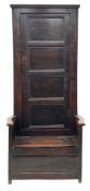 Early 18th century country oak bacon settle, tall raised cupboard back enclosed by paneled door, box