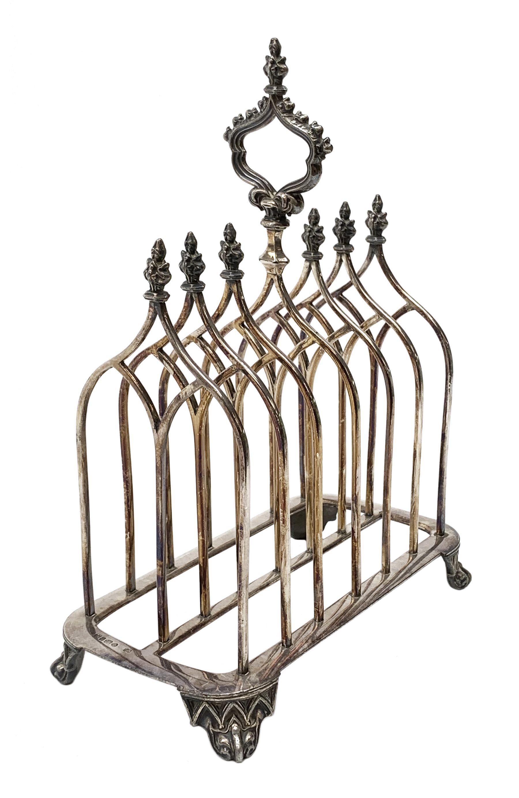 Victorian electroplate Gothic style toast rack, with seven arched bars, openwork handle and arcaded