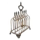 Victorian electroplate Gothic style toast rack, with seven arched bars, openwork handle and arcaded